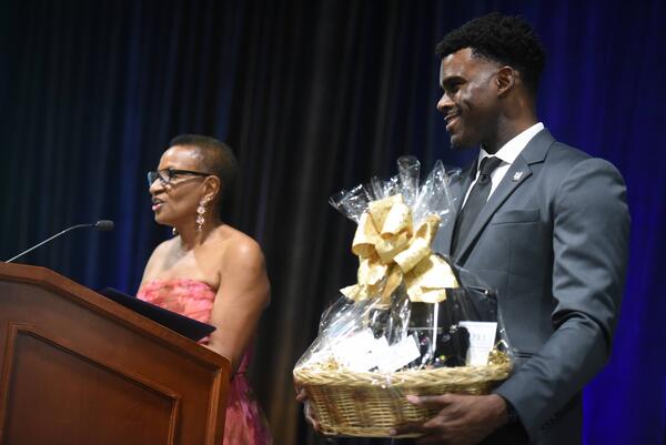 Dean Deas and Vladimir Oge holding a gift basket